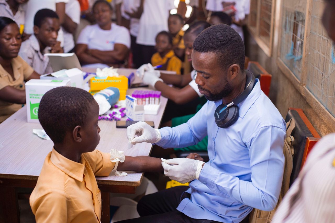 A basic school student being screened for SCD using POCT